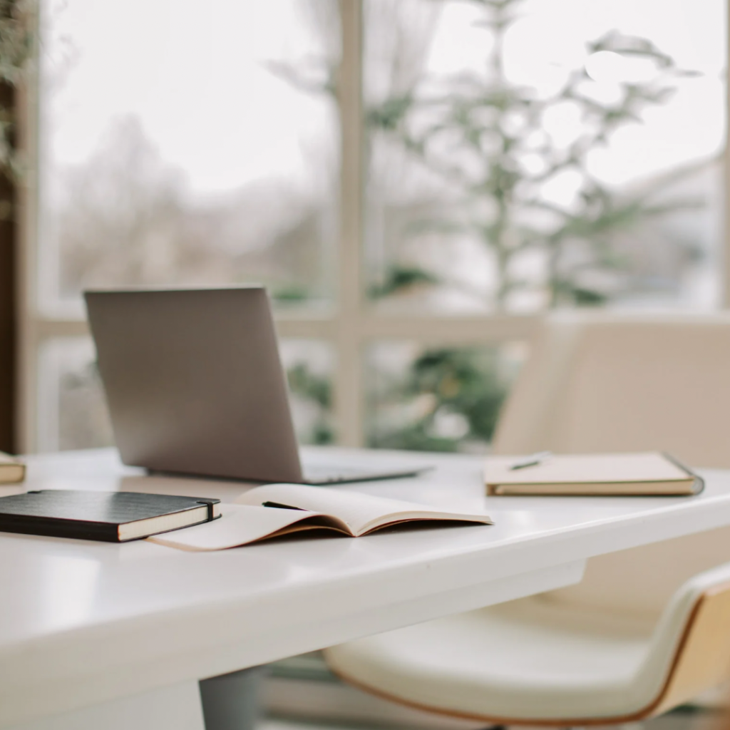 Picture of a desk with books and laptop