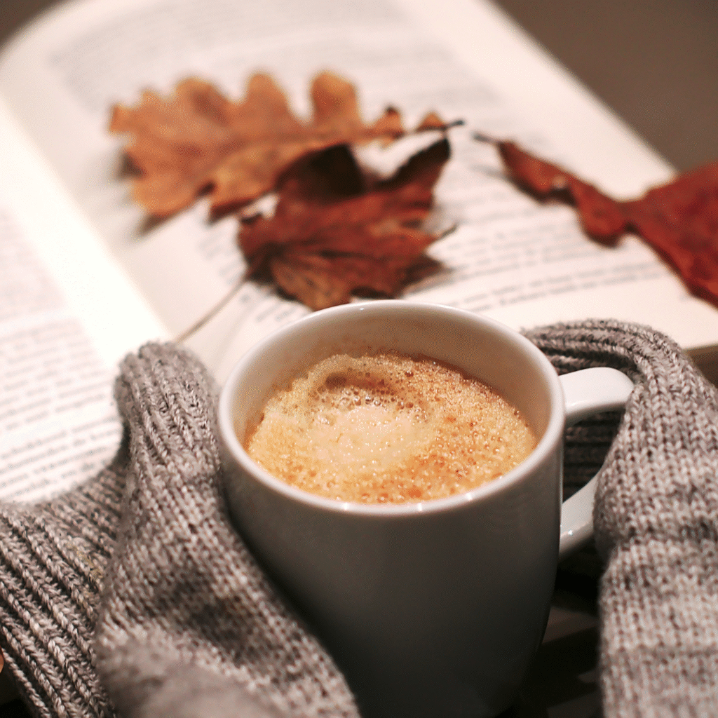 Autumn office pumpkin spiced latte and autumn leaves