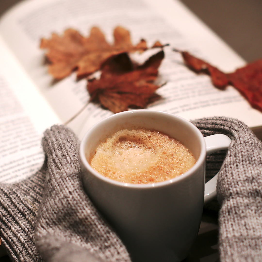 Autumn office pumpkin spiced latte and autumn leaves